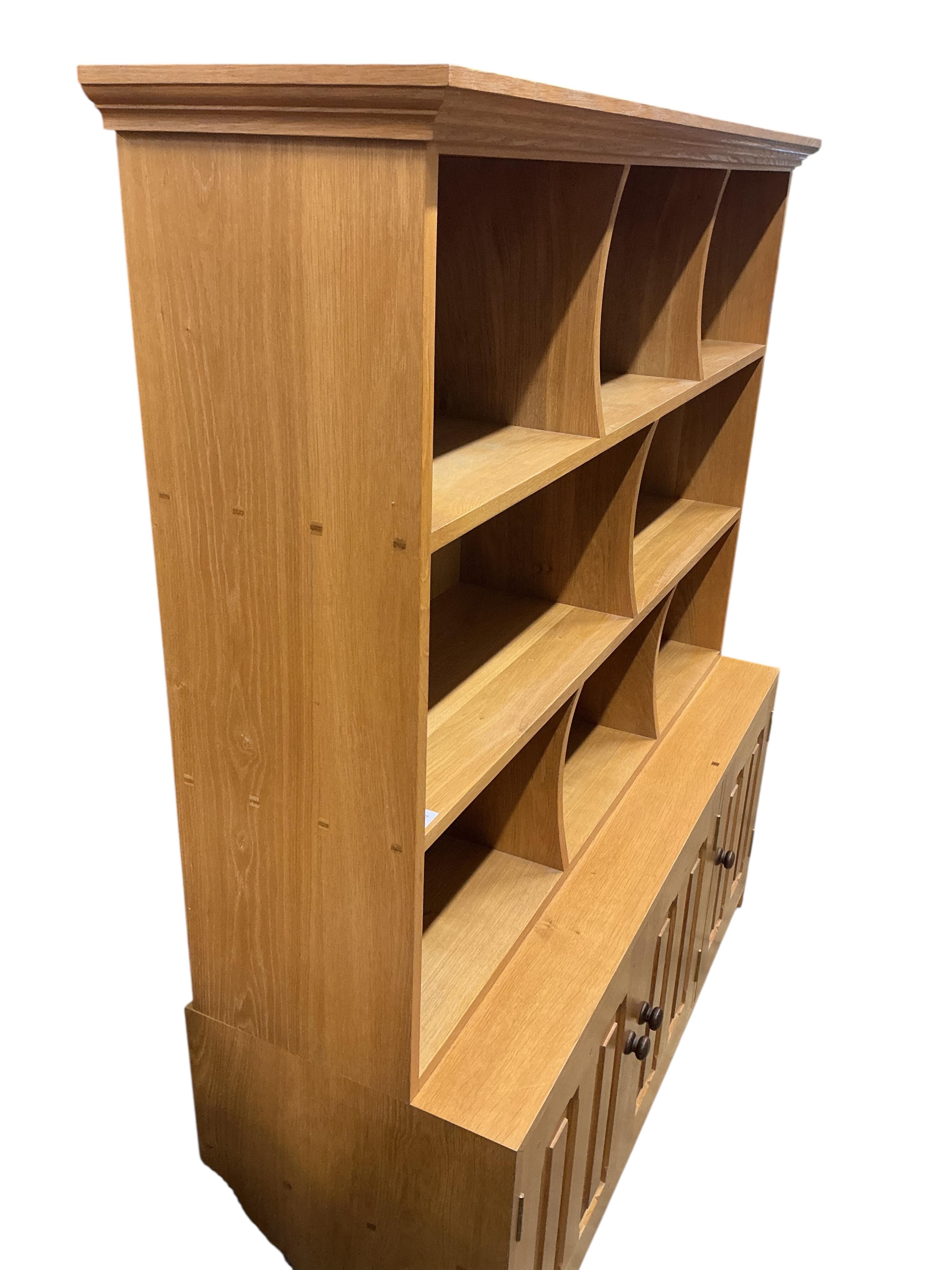 A Contemporary bespoke oak open bookcase, cupboards below, width 141cm, depth 46cm, height 169cm